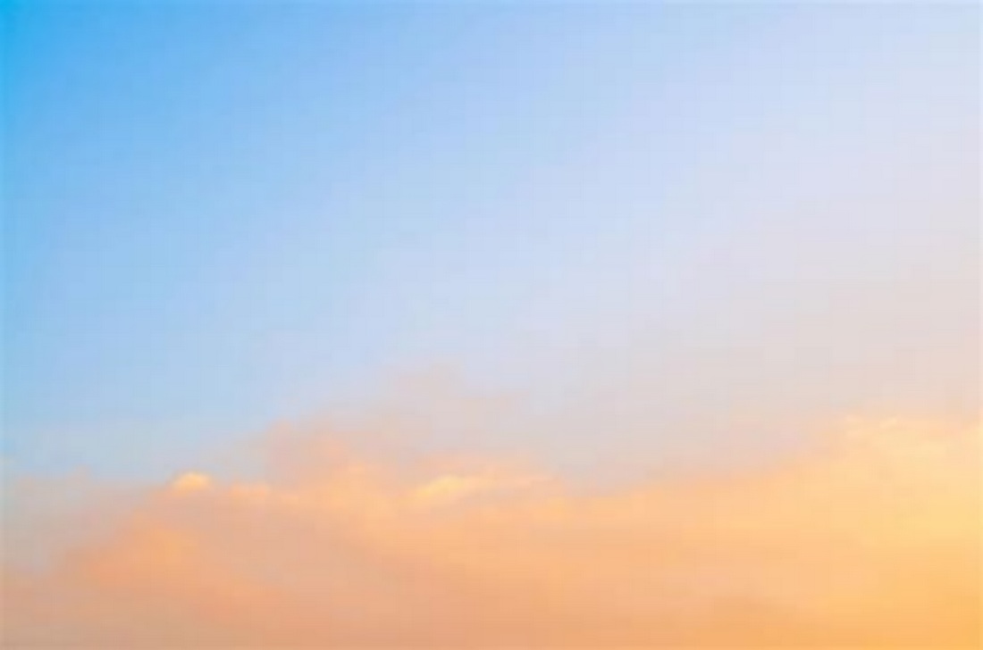 sun shining on clouds in blue sky